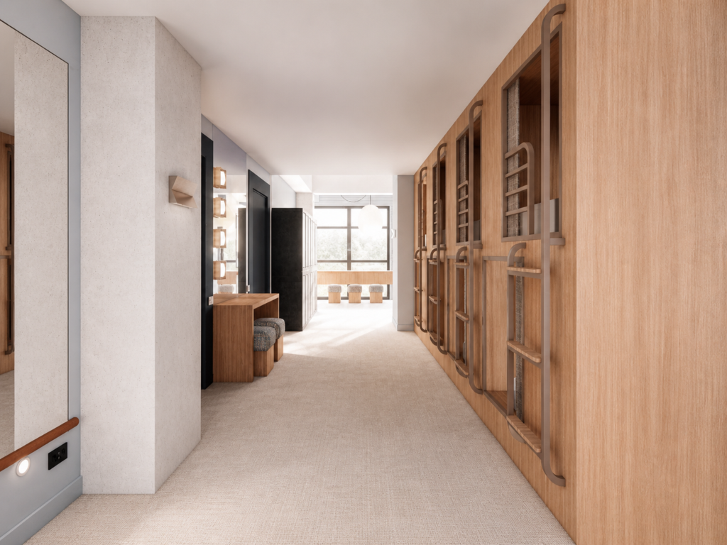 Bright, modern dressing room corridor with wood-paneled wall on the right, seating, and mirrored vanity area at the far end.