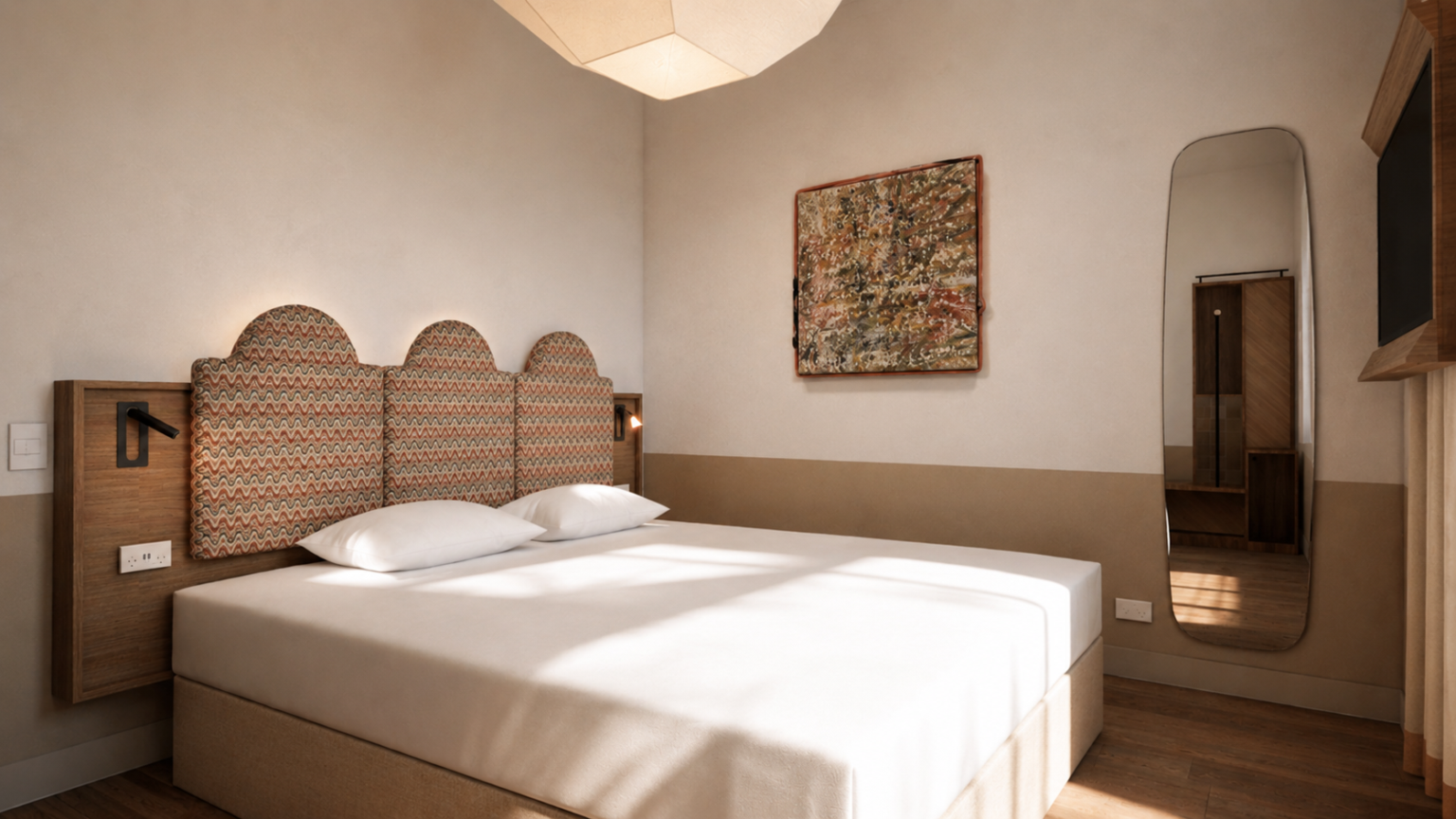 Hotel room with a large bed, white linens, and a distinctive wavy-patterned upholstered headboard against a beige wall.