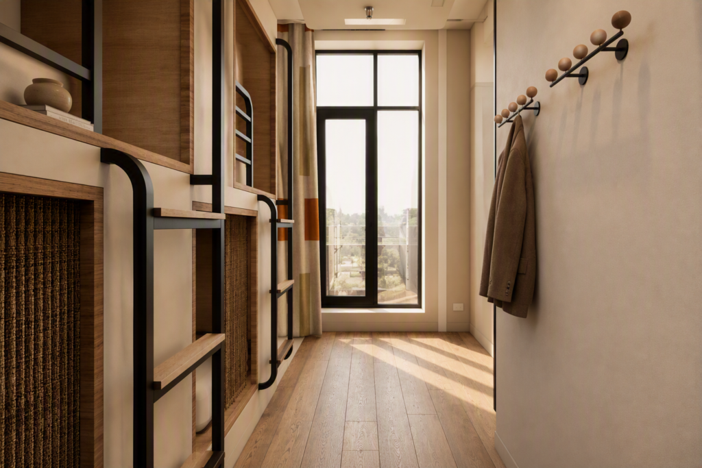 Narrow hallway with built-in wooden shelves and black metal supports, coat hooks on the right, and a large window at the end letting in light.