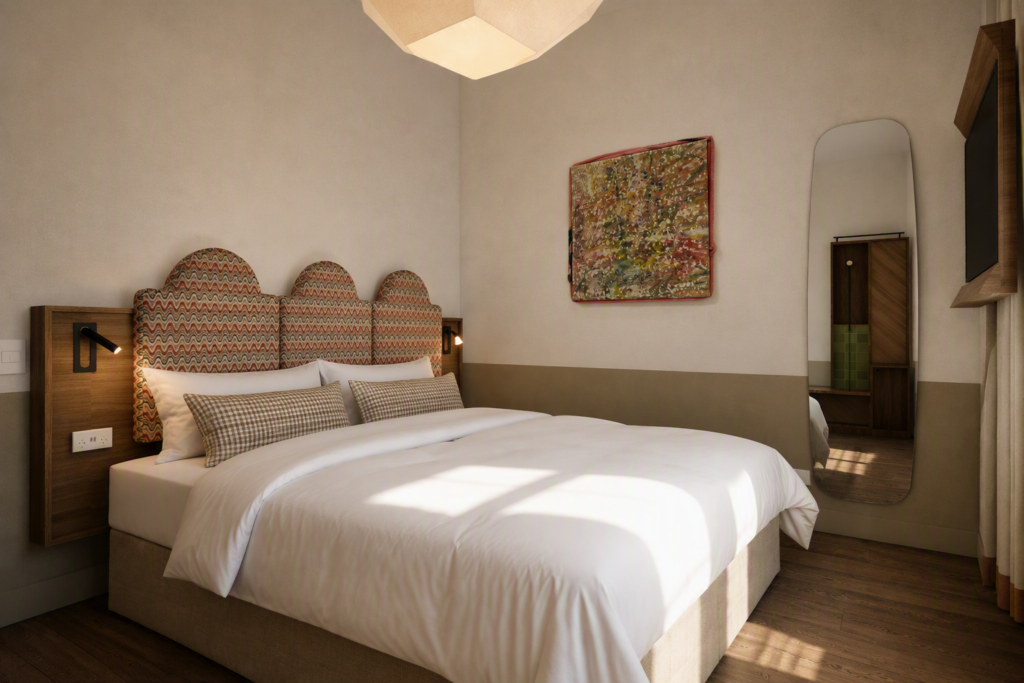 King bed with a multi-panel, wavy-pattern headboard, two bedside lamps, and white linens in a modern hotel room.